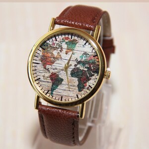 May include: A brown leather wristwatch with a gold-tone case. The watch face features a colorful world map design.
