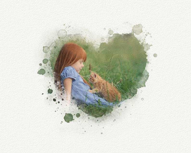 May include: A young girl with red hair sits in a field of green grass, looking down at a small orange kitten. The image is framed with a watercolor heart shape.