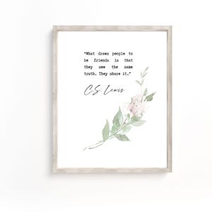 May include: A white framed print with a quote by C.S. Lewis about friendship. The quote reads "What draws people to be friends is that they see the same truth. They share it." The print features a watercolor illustration of a delicate pink flower with green leaves.