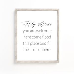 May include: A framed print with a white background and black text that reads "Holy Spirit you are welcome here come flood this place and fill the atmosphere."