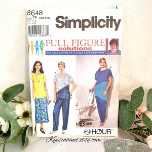 May include: Simplicity sewing pattern 8648 for full figure solutions. The pattern features illustrations of tops and pants. The front of the package has the Simplicity logo and the text "FULL FIGURE solutions". The size is 18W-24W.