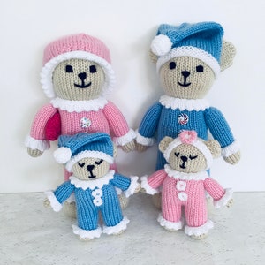 Knitting pattern for bedtime teddy bears. Mum and dad are 10 inch, babies are 6 inch. Mum and girl are mainly pink with white trim. Mum has a pink hat, girl has white headband. Dad and boy are mainly blue with white trim both wearing nightcaps.