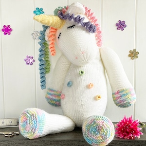 Unicorn knitting pattern 17 inch when sitting down. White body and head, white arms and legs with multi coloured hooves. Yellow horn and lots of rainbow coloured curly mane. Knit flat and seamed.