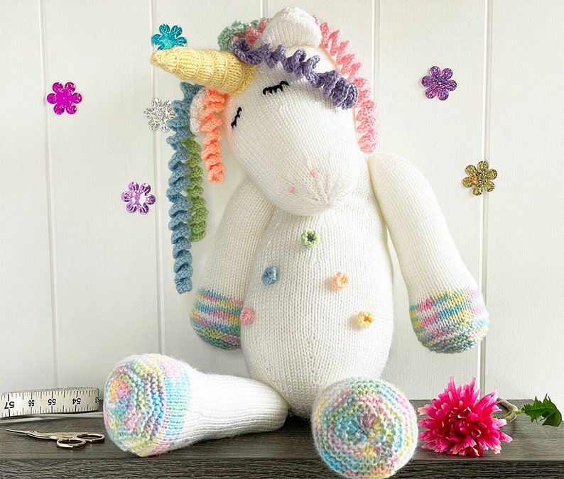 Unicorn knitting pattern 17 inch when sitting down. White body and head, white arms and legs with multi coloured hooves. Yellow horn and lots of rainbow coloured curly mane. Knit flat and seamed.