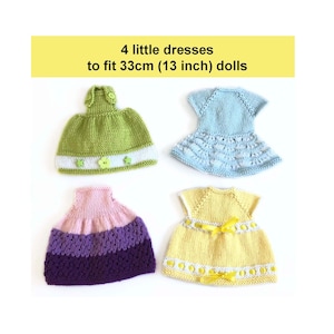 May include: Four hand-knitted doll dresses in various colors: green, blue, pink, and yellow. The dresses are designed to fit 13-inch dolls. The green dress has a white stripe and star accents. The image includes the text: "4 little dresses to fit 33cm (13 inch) dolls."