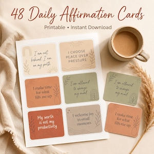 May include: A set of 48 daily affirmation cards featuring various earth-toned rectangles with rounded corners. Each card displays unique text, such as I am not behind; I am on my path, I choose peace over pressure, I make time for what fills me up, I am allowed to change my mind, my worth is not my productivity, and I welcome joy in small moments.