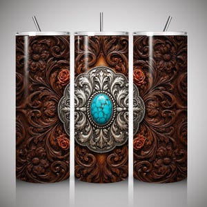 May include: A cylindrical tumbler with a straw featuring a dark brown faux leather texture with embossed floral scrollwork and small red roses. The center displays a large, ornate silver concho medallion set with a bright turquoise stone.