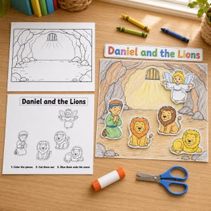 May include: A Daniel and the Lions craft kit featuring a coloring page of a cave, a sheet with cut-out figures of a person, lions, and an angel, and a completed colored scene. Includes a glue stick, blue-handled scissors, and two crayons.