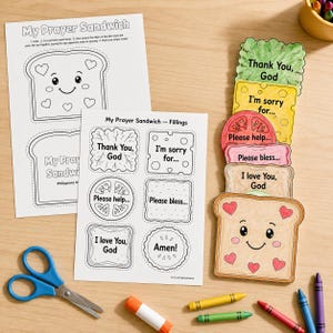 May include: A My Prayer Sandwich craft activity set featuring two printed paper sheets with outlines of bread and sandwich fillings, alongside a stack of coloured paper cutouts including lettuce, cheese, tomato, meat, and bread with heart patterns.