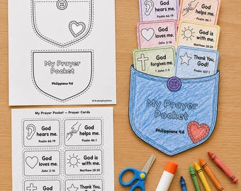 May include: A paper craft activity set featuring a blue coloured paper pocket labelled My Prayer Pocket with Philippians 4:6, accompanied by six colourful prayer cards, two instruction sheets, a pair of blue scissors, a glue stick, and five crayons.