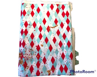 1 Yard Argyle theme in Teal, red with spots of glitter throughout Background in this cotton Woven fabric.