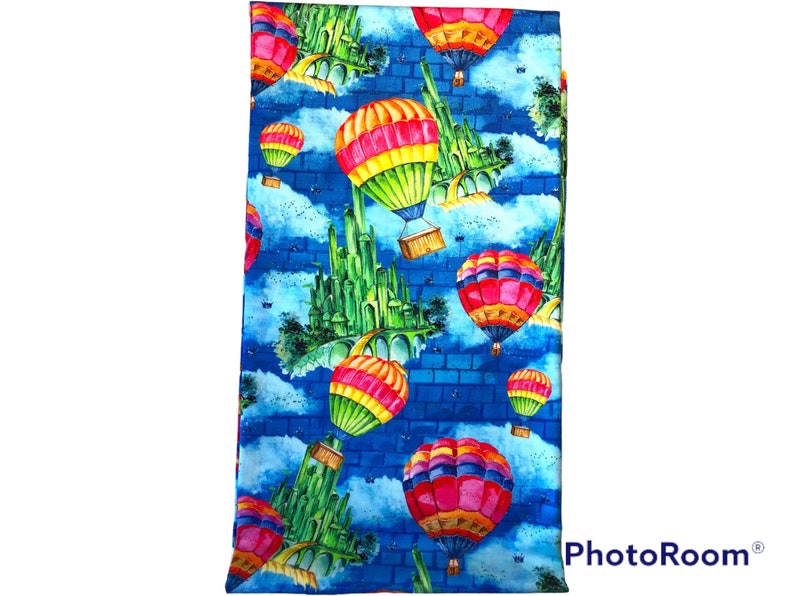 1 yard Wizard of Oz Cotton Woven Blue brick background with Balloon and Emerald City. image 1