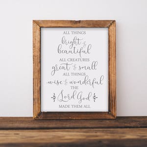 May include: A framed print with a white background and black text that reads "All things bright & beautiful, All creatures great & small, All things wise & wonderful, The Lord God made them all."