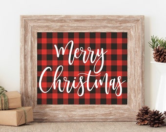 May include: A framed print with a red and black buffalo plaid pattern and the text "Merry Christmas" in white cursive font.