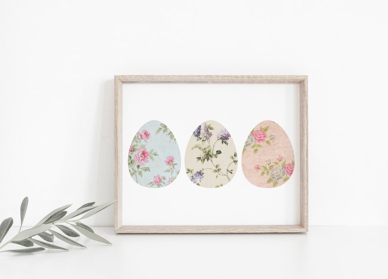 May include: A framed print of three pastel-colored Easter eggs with floral patterns. The eggs are arranged horizontally in a row.