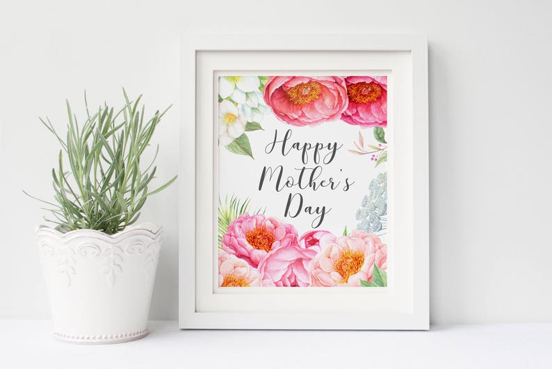 May include: White framed print with watercolor flowers in shades of pink, white, and green. The text "Happy Mother's Day" is written in black cursive.