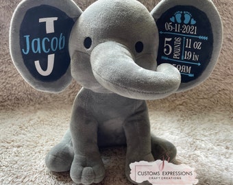 May include: Gray plush elephant with a black and white tag on each ear. The left ear tag says "Jacob J" and the right ear tag says "05-11-2021 5 pounds 11 oz 19 in 9AM".