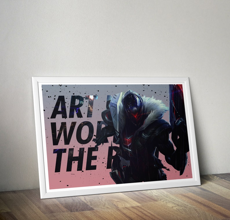 May include: A framed print featuring a black and white illustration of a masked figure with a large weapon. The text "Art is work, the rest is just play" is printed on the image.
