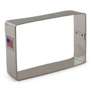 May include: A silver rectangular cookie cutter with a "Made in USA" label.
