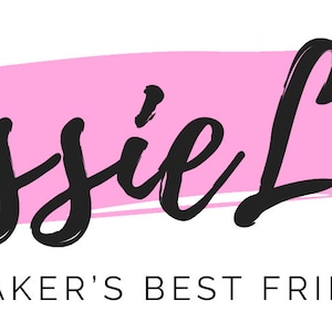 May include: Pink brushstroke background with the text "Lissie Lou" in black cursive lettering. Below the text is the phrase "A Baker's Best Friend" in black.
