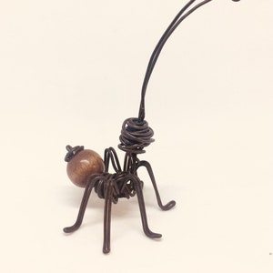 Brown and black ant. Ant on iron wire and wood. Dark brown. Insects for decoration