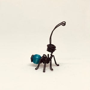 Blue ant. Color ant. Ant in iron and wood thread. Funny ant. Insects for decoration. Funny ant. Sculpture