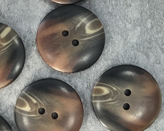May include: Four brown and cream swirl patterned buttons with two holes each.