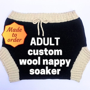 May include: A black and beige knitted wool nappy soaker with a drawstring waist. The text "ADULT custom wool nappy soaker" is displayed on the front. The words "Made to order" are in a yellow and orange badge.