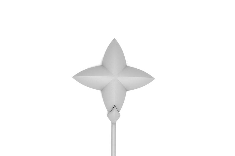 May include: A white, four-pointed star-shaped ornament with a long, thin stem. The ornament is made of paper and has a simple, elegant design.