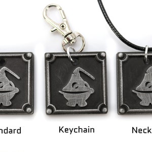 May include: Three metal pendants featuring a stylized cartoon character with a round body and a single arm. The pendants are available in three styles: standard, keychain, and necklace.