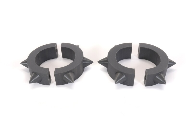 May include: Two grey plastic rings with spikes, each ring is split into two pieces.