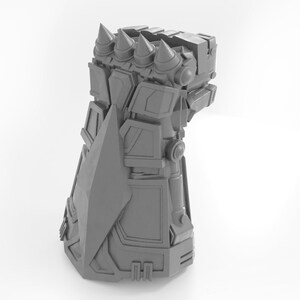 May include: A gray 3D printed model of a robotic hand with a sharp blade and multiple spikes on the fingers.