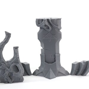 May include: A set of five gray 3D printed miniature dungeon pieces, including a pillar with a triangular symbol, a broken pillar, a tree stump, and two smaller pieces.
