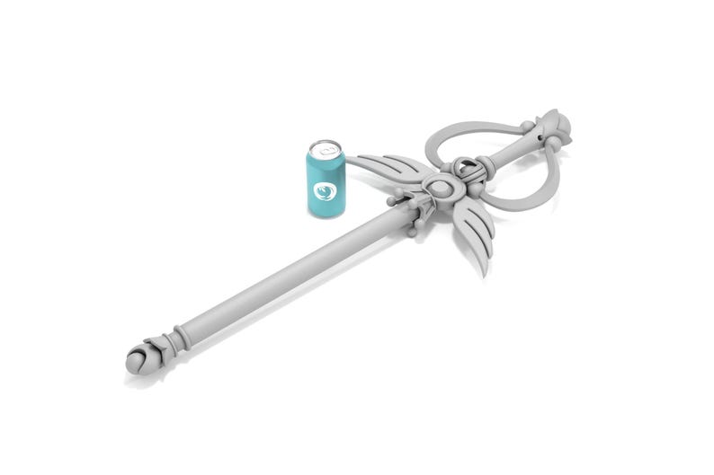 May include: A white, ornate wand with a heart-shaped handle and a winged design. The wand is lying on a white surface next to a blue can.