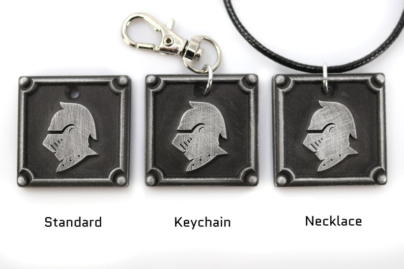 May include: Three silver-toned metal pendants with a knight's helmet design. The pendants are shown in three different styles: standard, keychain, and necklace.