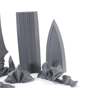 May include: A set of five gray 3D printed pieces that make up a sword. The pieces include the blade, hilt, pommel, and two decorative pieces.