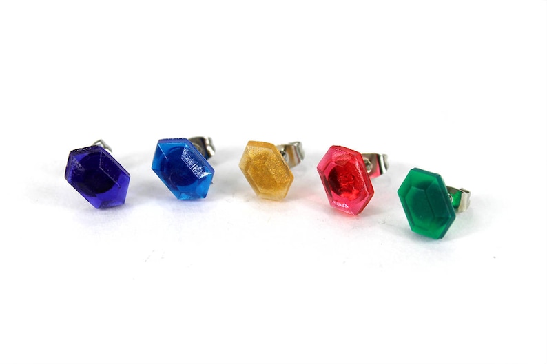 May include: Five colorful, octagonal-shaped earrings with silver posts. The earrings are blue, gold, red, green, and purple.