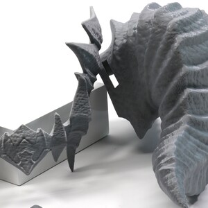 May include: Two 3D printed gray plastic dragon head sculptures. One is a full head and the other is a smaller, more detailed head.