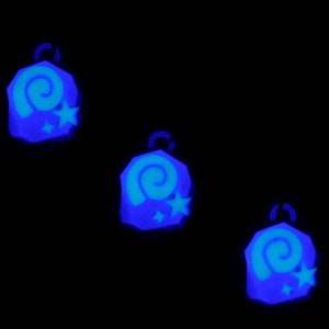May include: Three blue glow-in-the-dark charms with a spiral and star design.