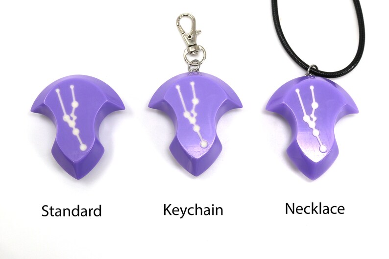 May include: Three purple pendants with a white constellation design. The pendants are shown in three different styles: standard, keychain, and necklace.
