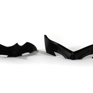 May include: Two black plastic pieces shaped like a bat, one is a full bat shape and the other is a bat wing shape.