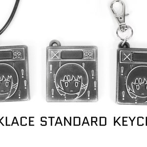 May include: Three silver-toned metal charms featuring a cartoon character with exclamation points around the character. The charms are available as a necklace, keychain, and standard keychain.
