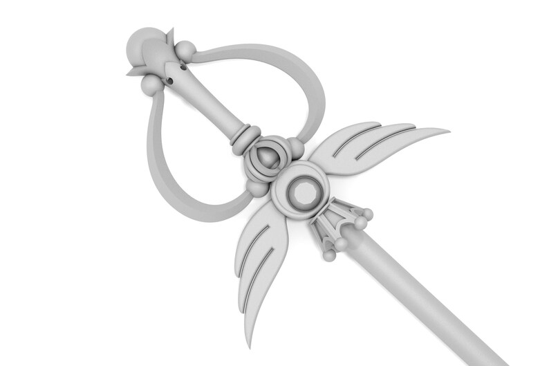 May include: A white, ornate wand with a heart-shaped loop, wings, and a crown-like tip. The wand is made of a smooth, shiny material.