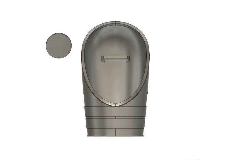 May include: A 3D-rendered, light gray object with a rounded, elongated shape, featuring a rectangular slot at the top and a circular disc to the left. The object has a smooth, metallic appearance, suggesting a possible industrial or mechanical component.