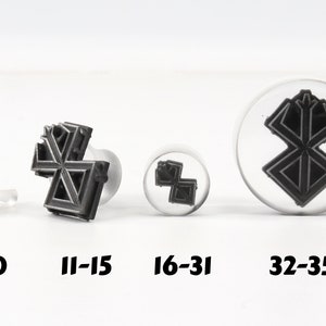 May include: Four different sizes of black and white rubber stamps with a geometric design. The sizes are labeled 3-10, 11-15, 16-31, and 32-35.