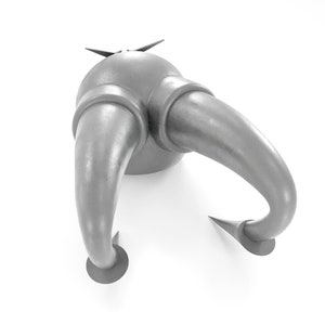 May include: A silver metal object with two curved horns and a pointed top. The object has a smooth, metallic finish and appears to be a decorative piece.