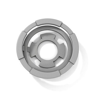 May include: A gray, circular, geometric design with concentric circles and a central shape resembling a flower.