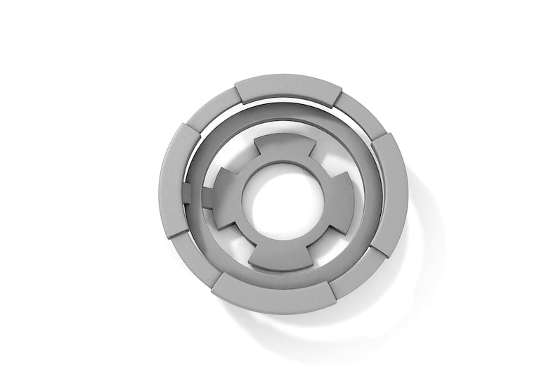 May include: A gray, circular, geometric design with concentric circles and a central shape resembling a flower.