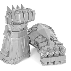 May include: A pair of silver-colored, articulated robot hands with spikes and a pointed tip. The hands are made of metal and have a futuristic design.