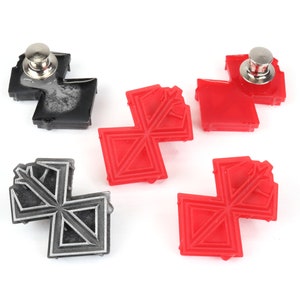 May include: Four pinback buttons with a geometric design. Two buttons are red and two buttons are black.